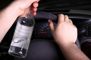 Driver with a bottle of alcohol